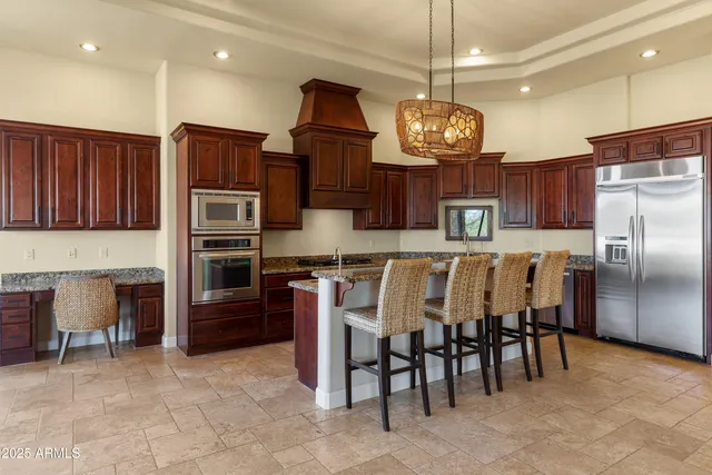 a dining room with furniture a chandelier and window