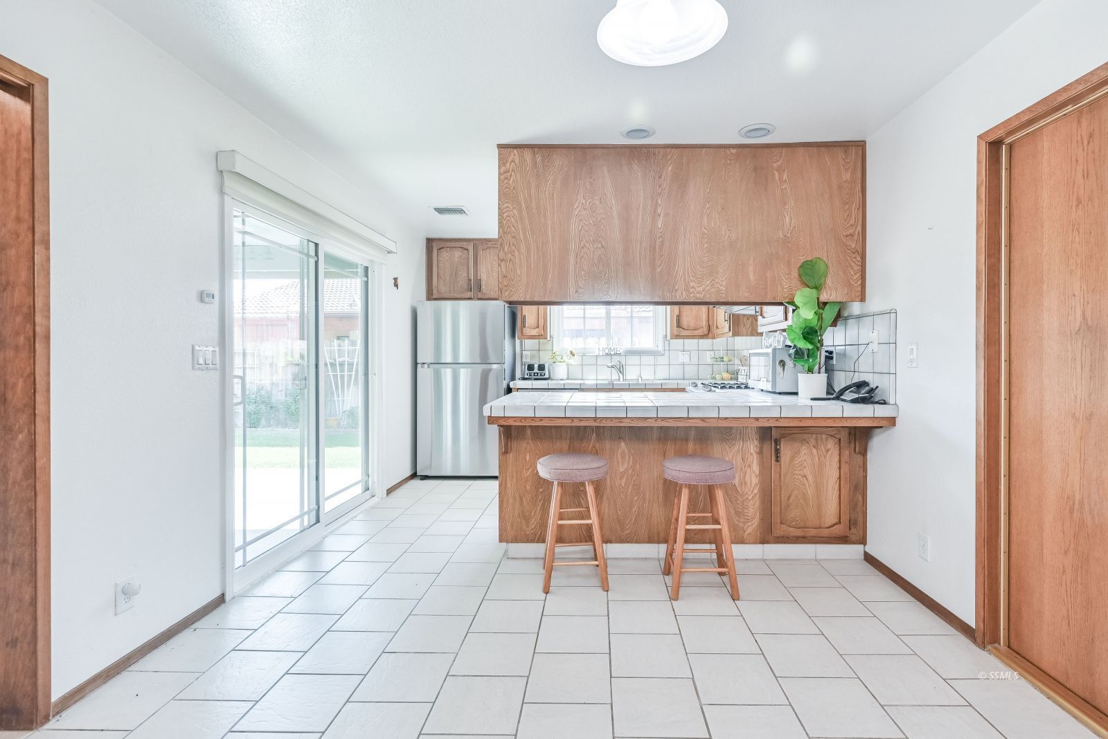 412 Lorene Court Ridgecrest, CA 93555 - Photo 3 of 31 a dining hall with stainless steel appliances a table and chairs