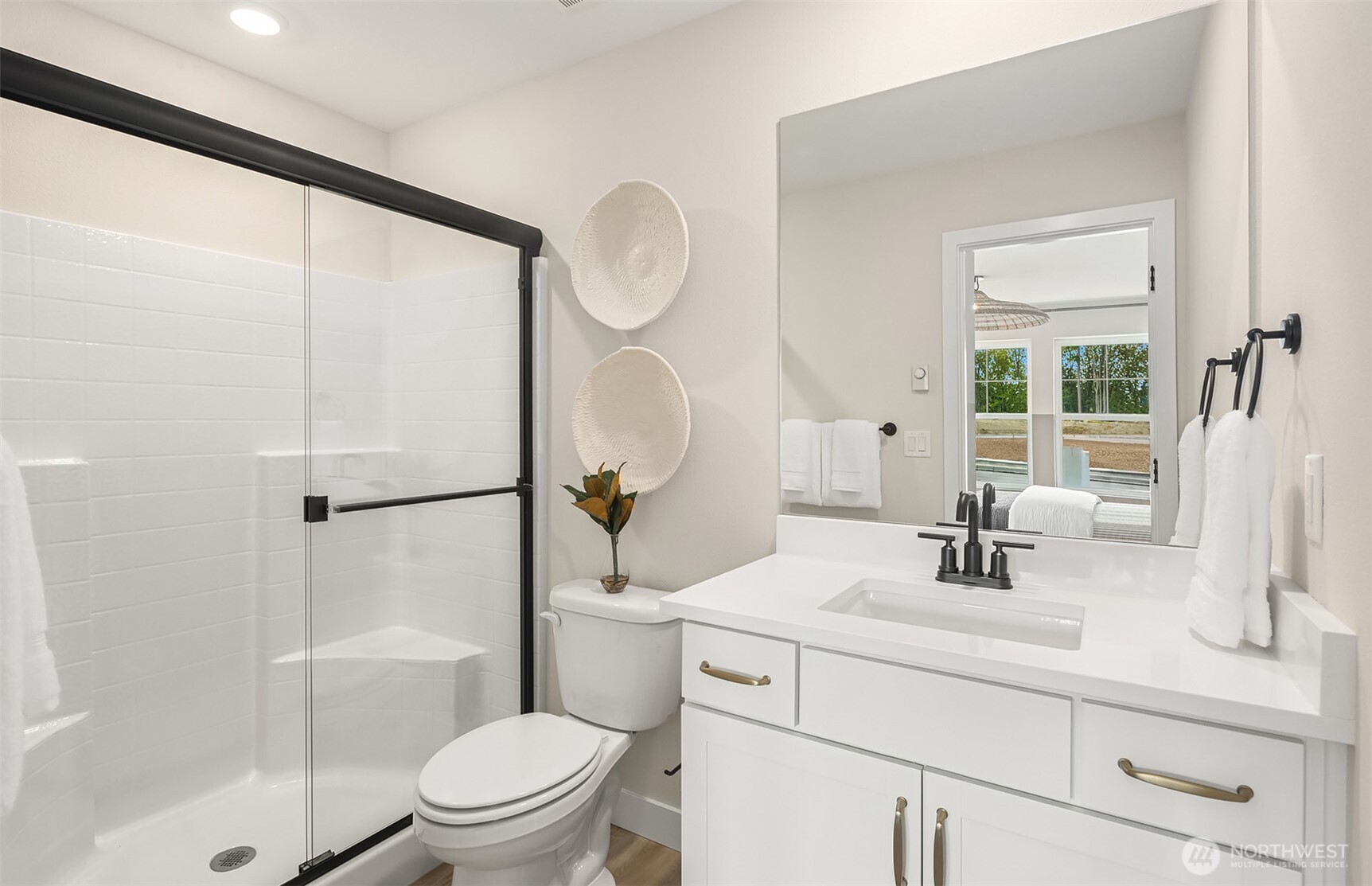 20341 90th Drive Northeast, Unit A Bothell, WA 98011 - Photo 4 of 17 a bathroom with a sink a toilet a mirror and shower