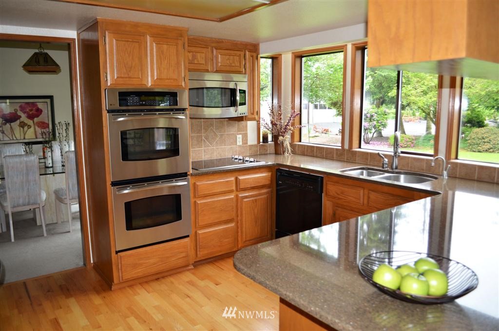1934 Rice Road Chehalis, WA 98532 - Photo 4 of 15 a kitchen with stainless steel appliances kitchen island granite countertop a stove a sink and a microwave
