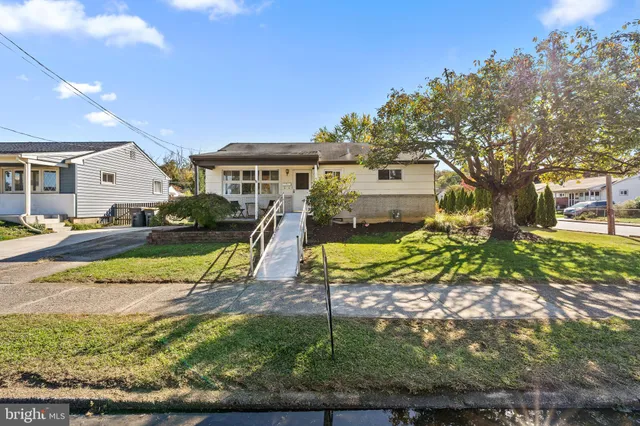 a view of a house with a yard patio and tree s