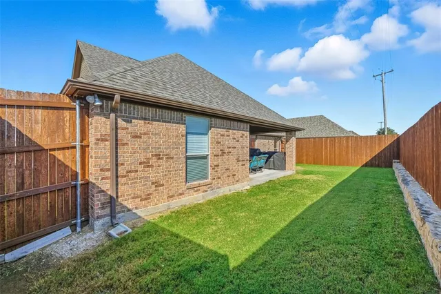 a front view of a house with yard and garage