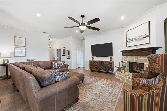a living room with furniture a flat screen tv and a fireplace