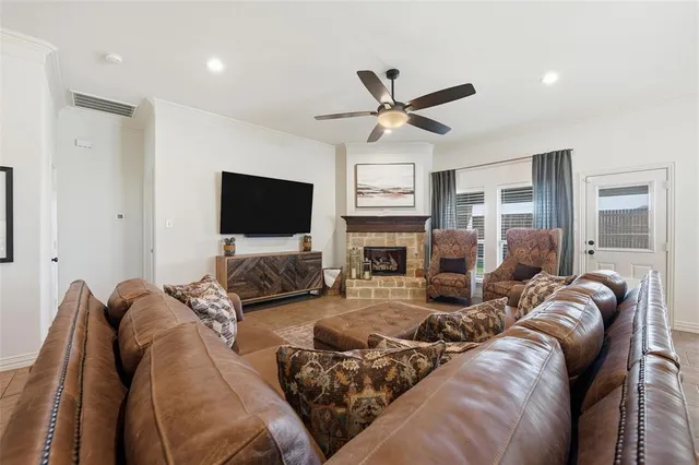 a living room with furniture a flat screen tv and a fireplace