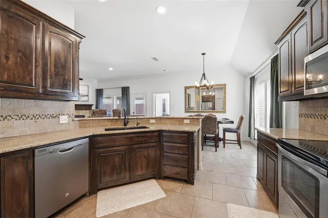 a kitchen with lots of counter top space and appliances