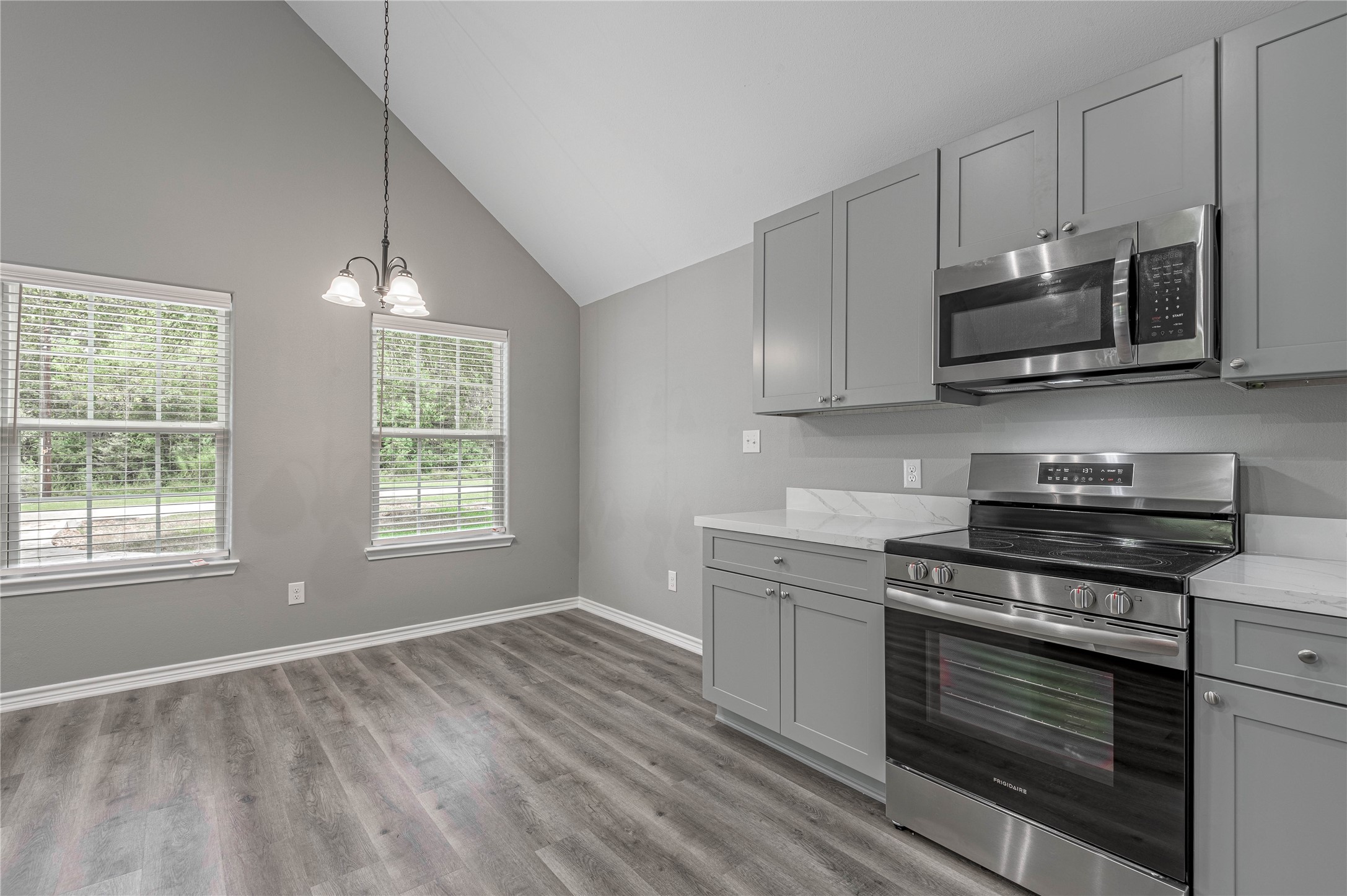 499 Pecan Onalaska, TX 77360 - Photo 12 of 30 a kitchen with stainless steel appliances a stove a microwave and cabinets