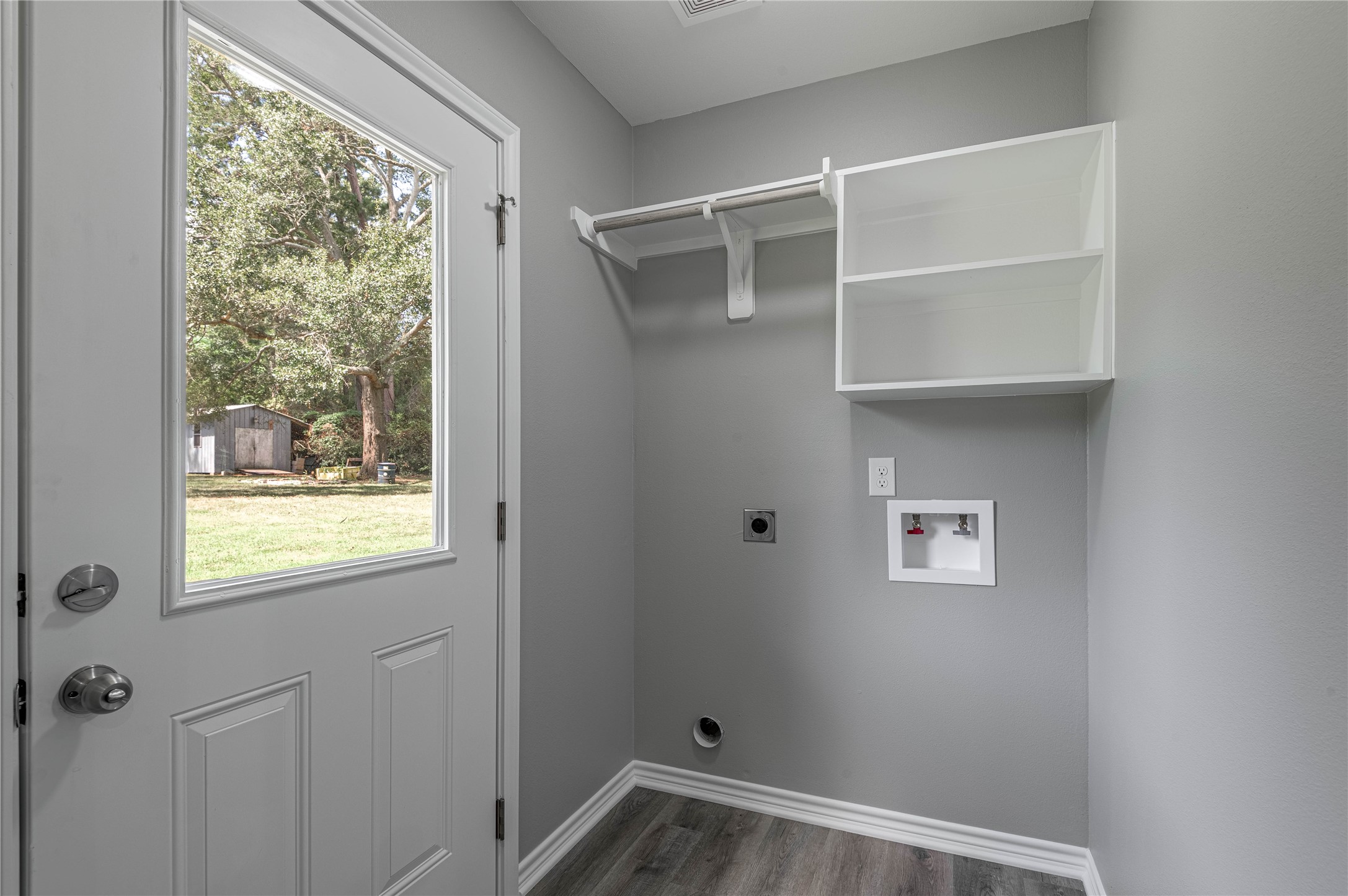 499 Pecan Onalaska, TX 77360 - Photo 13 of 30 a view of a room with rack on the wall and a window