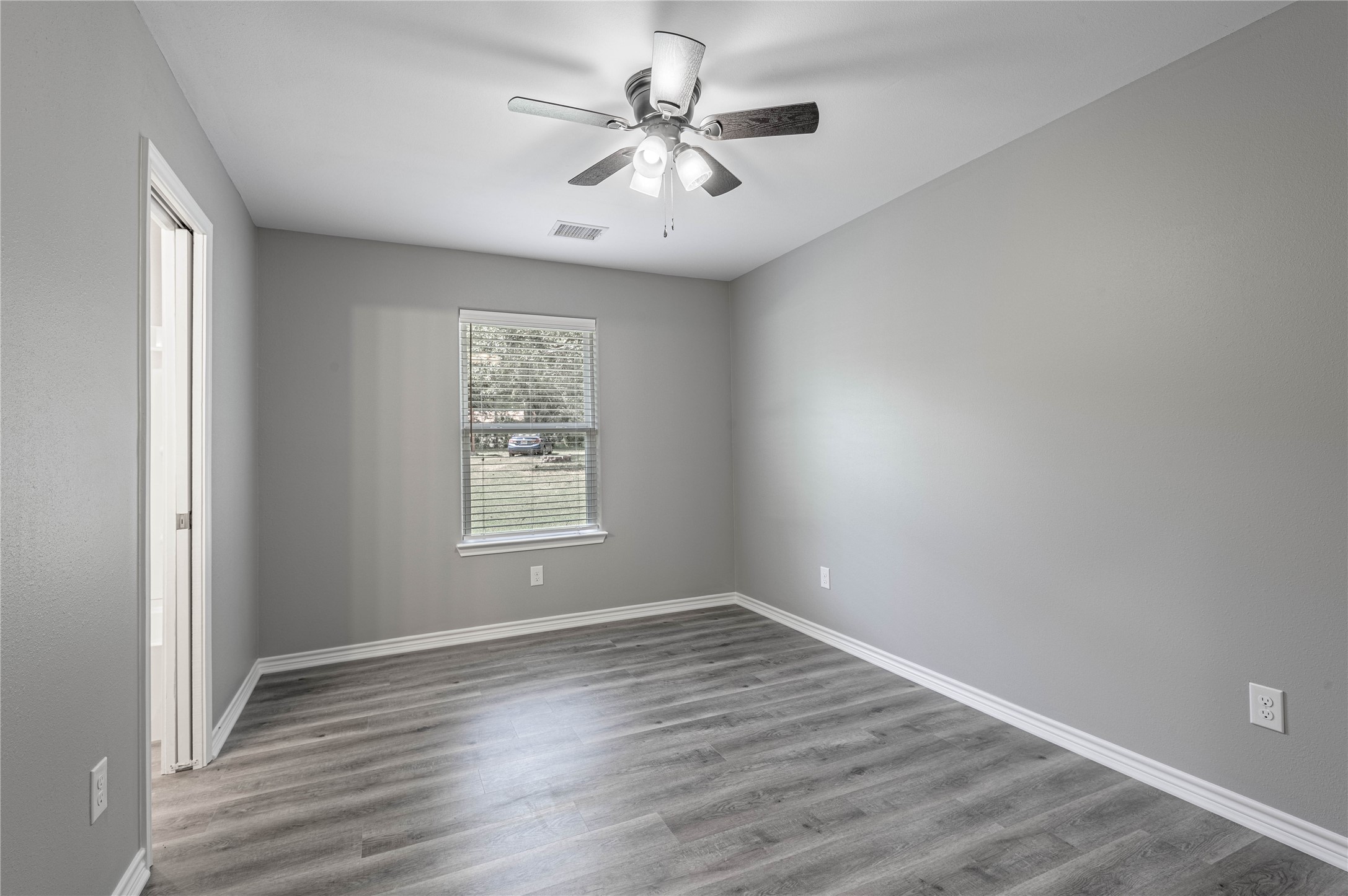 499 Pecan Onalaska, TX 77360 - Photo 14 of 30 wooden floor in an empty room with a window