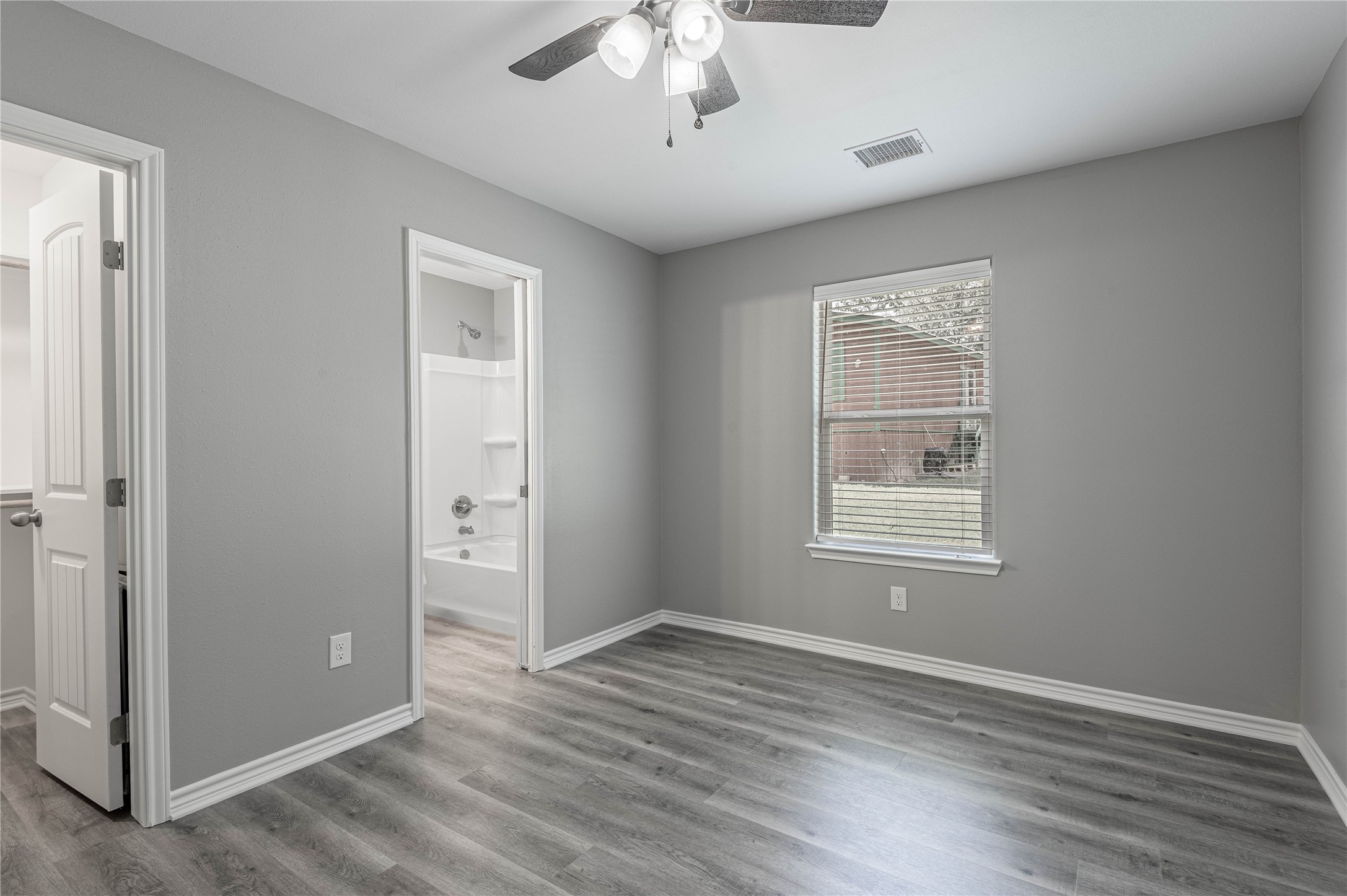 499 Pecan Onalaska, TX 77360 - Photo 15 of 30 an empty room with wooden floor chandelier and windows