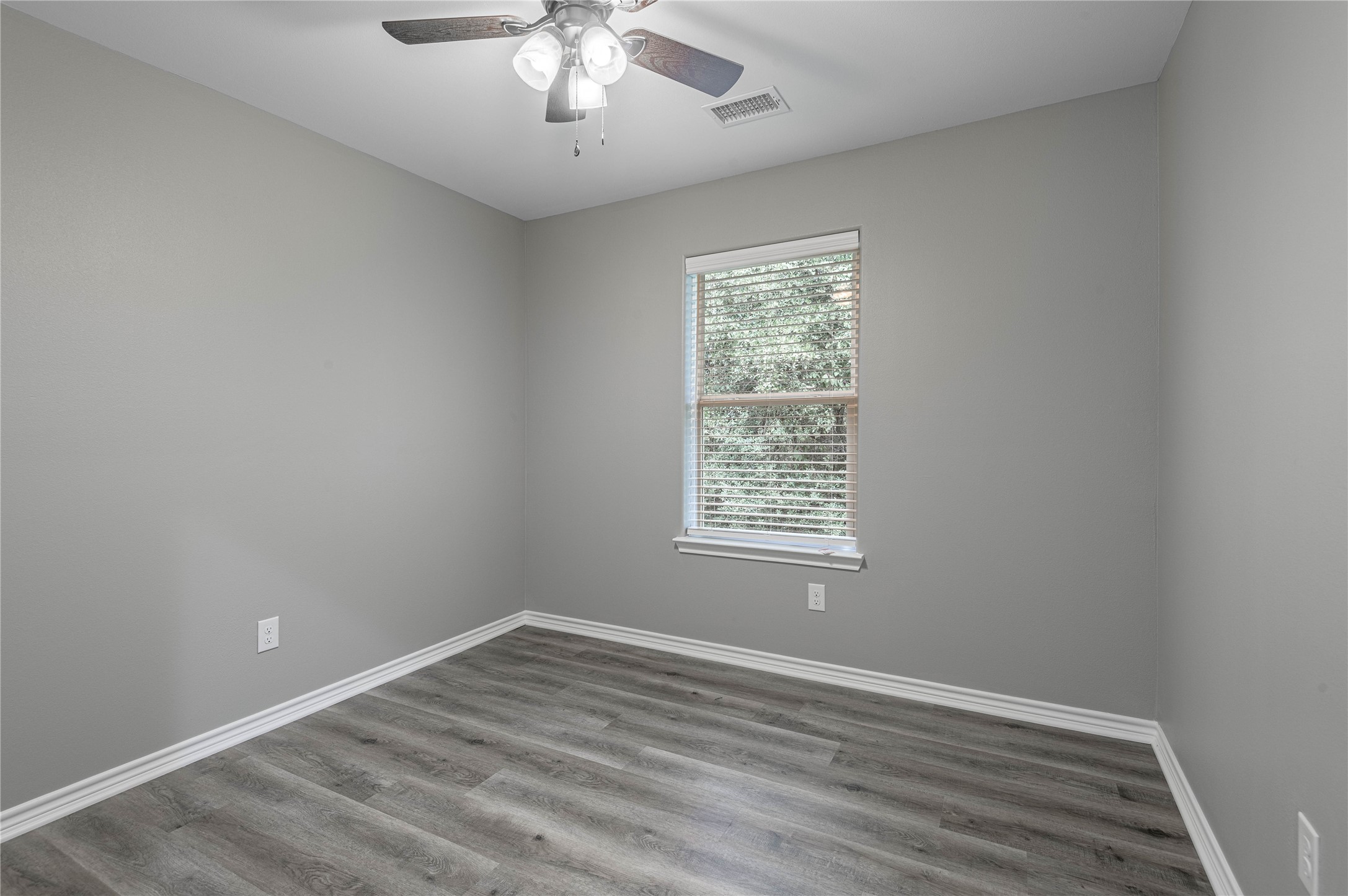 499 Pecan Onalaska, TX 77360 - Photo 18 of 30 wooden floor in an empty room with a window