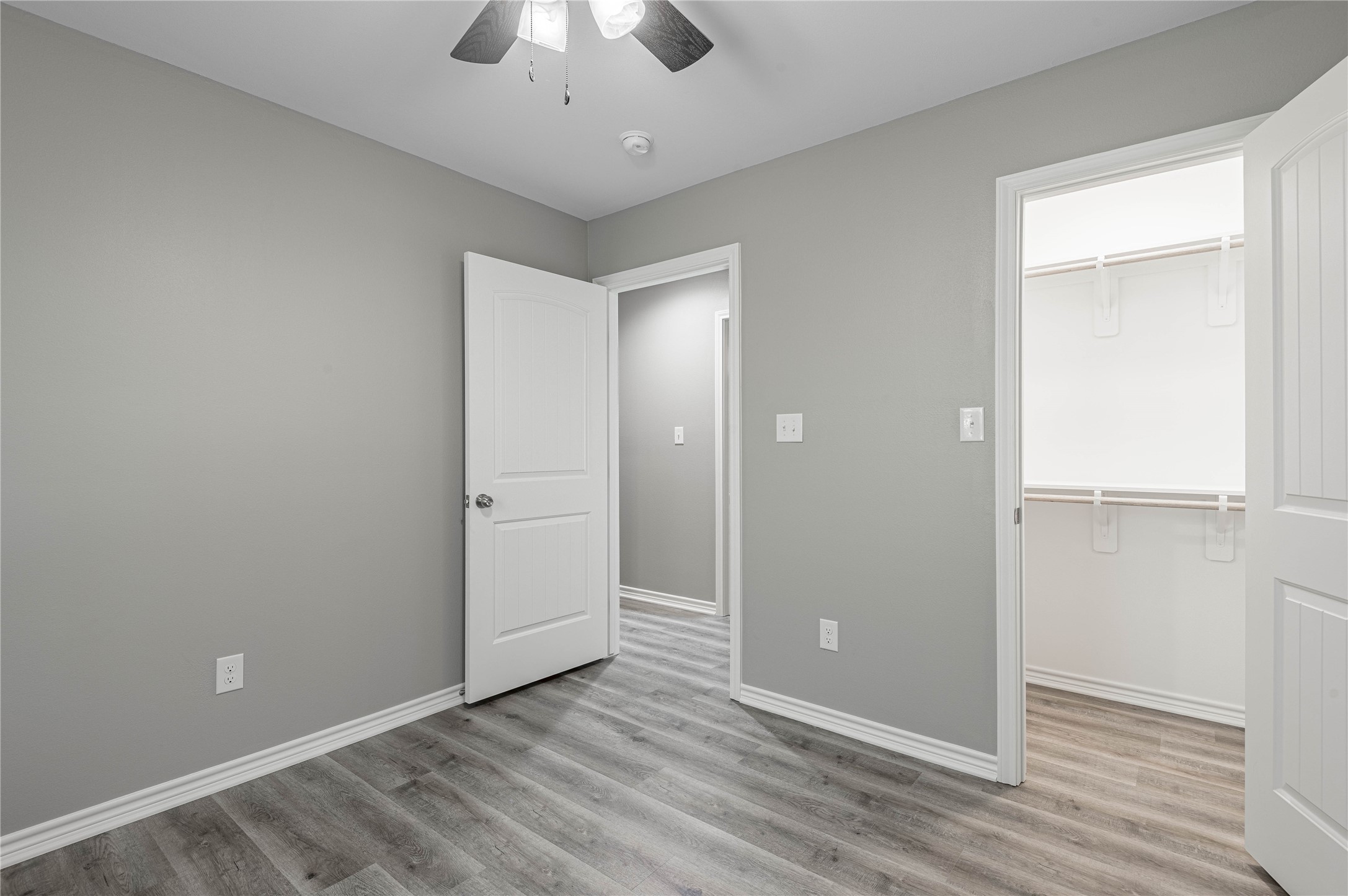 499 Pecan Onalaska, TX 77360 - Photo 20 of 30 an empty room with wooden floor and chandelier fan