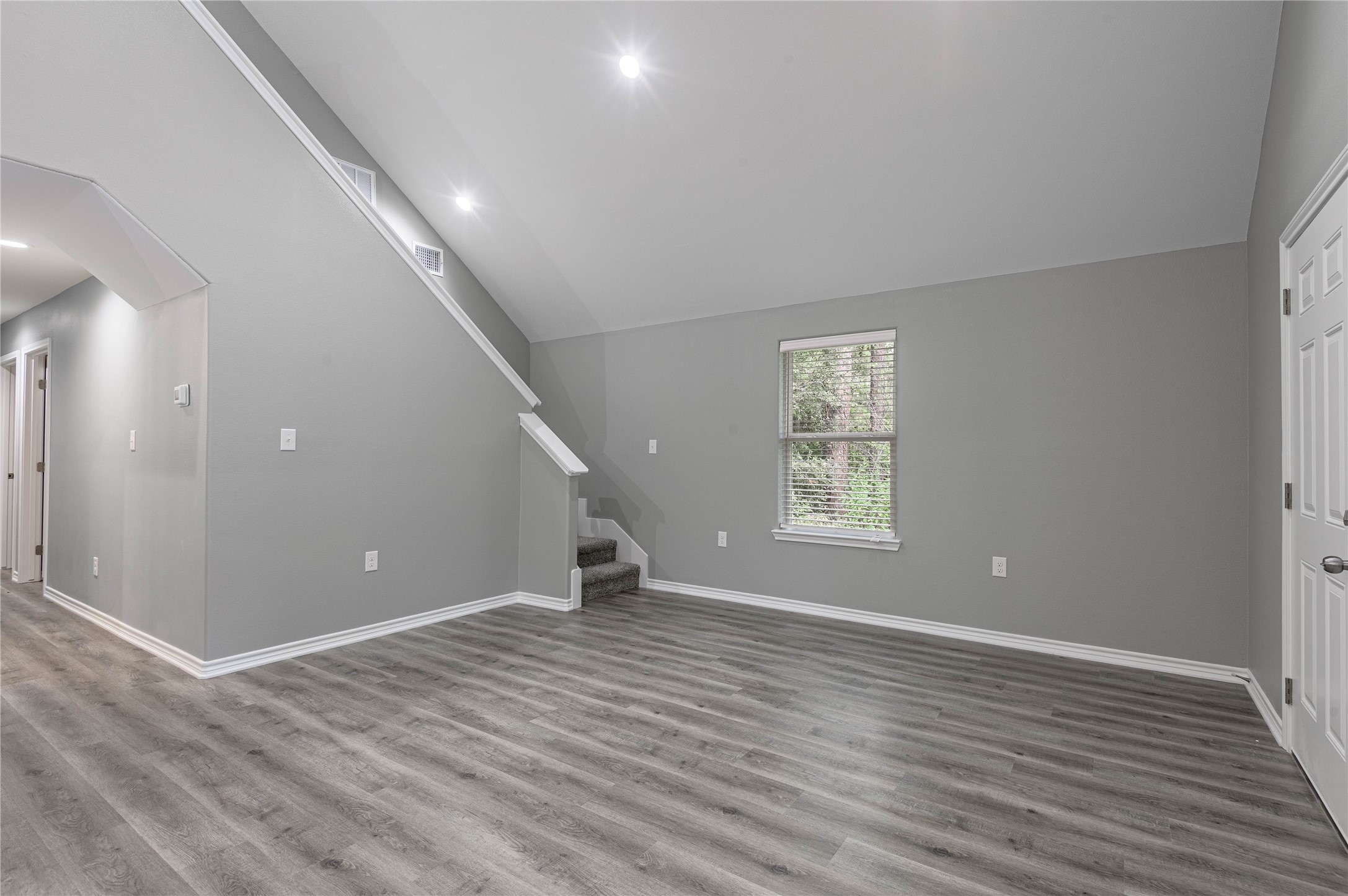 499 Pecan Onalaska, TX 77360 - Photo 6 of 30 a view of an empty room with wooden floor and a window