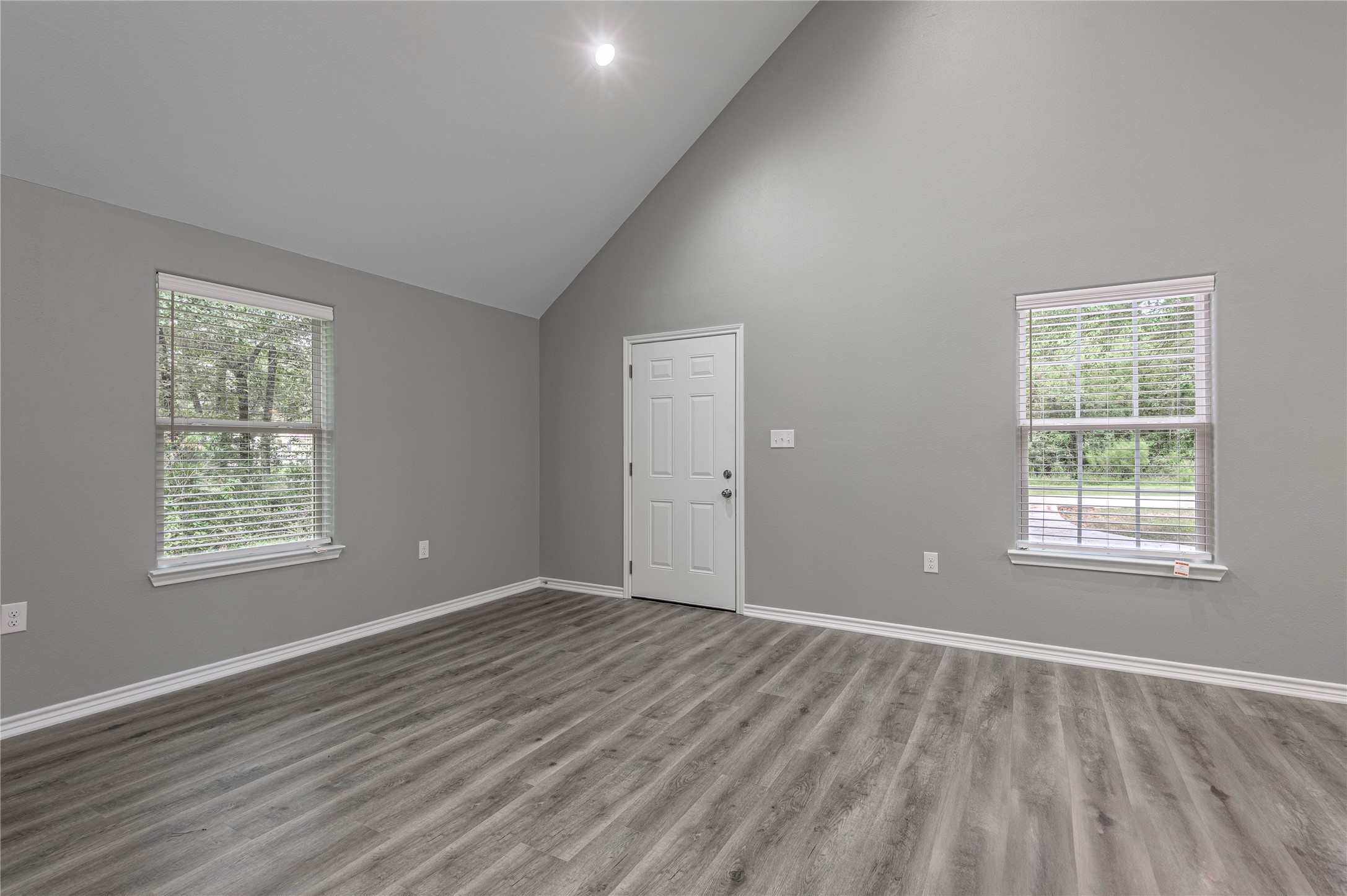 499 Pecan Onalaska, TX 77360 - Photo 7 of 30 an empty room with wooden floor and windows