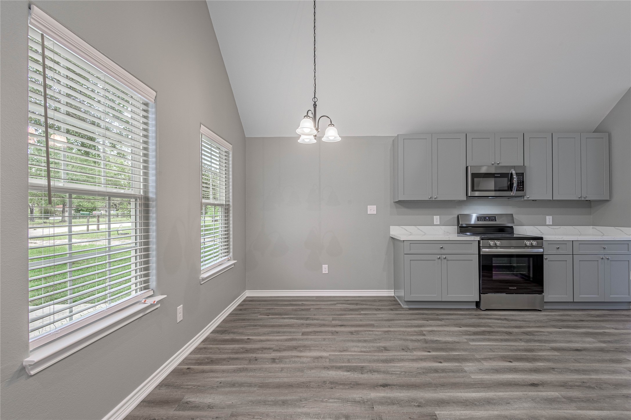 499 Pecan Onalaska, TX 77360 - Photo 8 of 30 a kitchen with stainless steel appliances granite countertop a stove a sink and a refrigerator