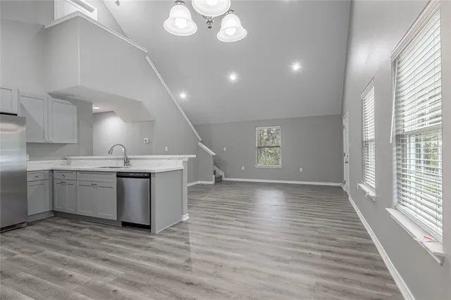 a view of a kitchen with a sink and wooden floor