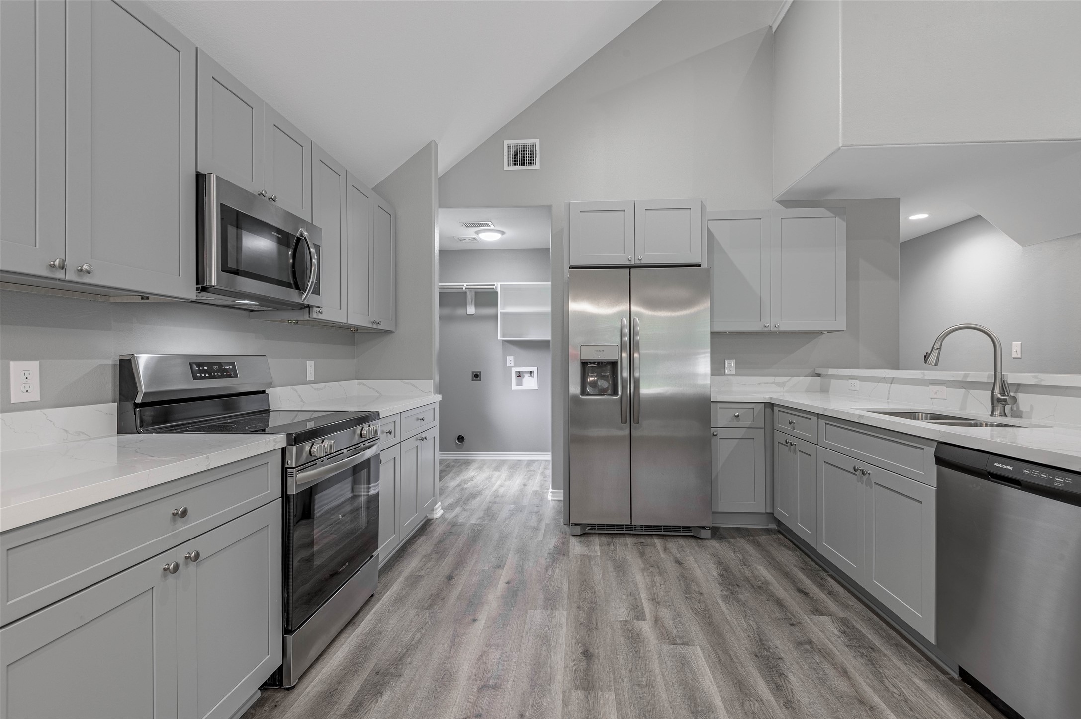 499 Pecan Onalaska, TX 77360 - Photo 10 of 30 a kitchen with granite countertop a sink stainless steel appliances and white cabinets
