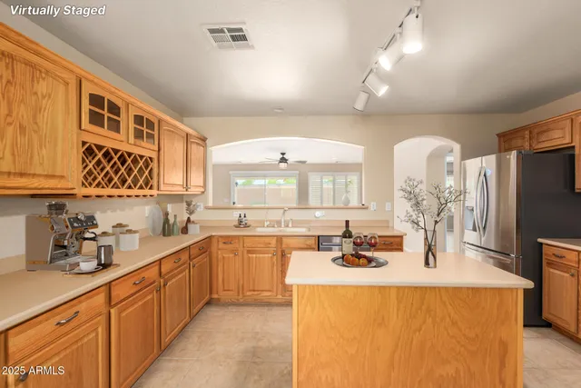 a kitchen with sink a microwave and cabinets