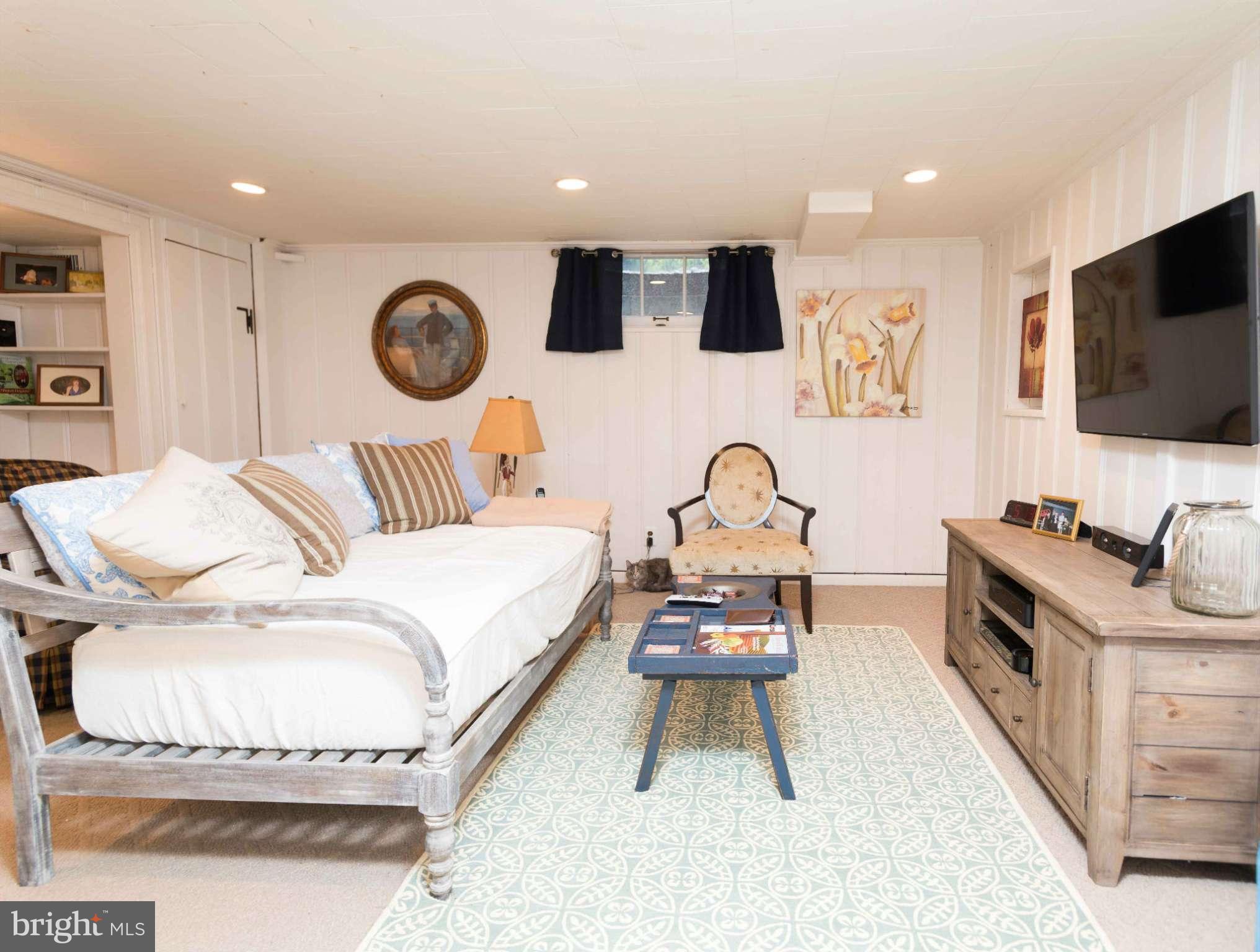 6420 Pinehurst Road Baltimore, MD 21212 - Photo 21 of 30 a bedroom with a bed and a flat screen tv