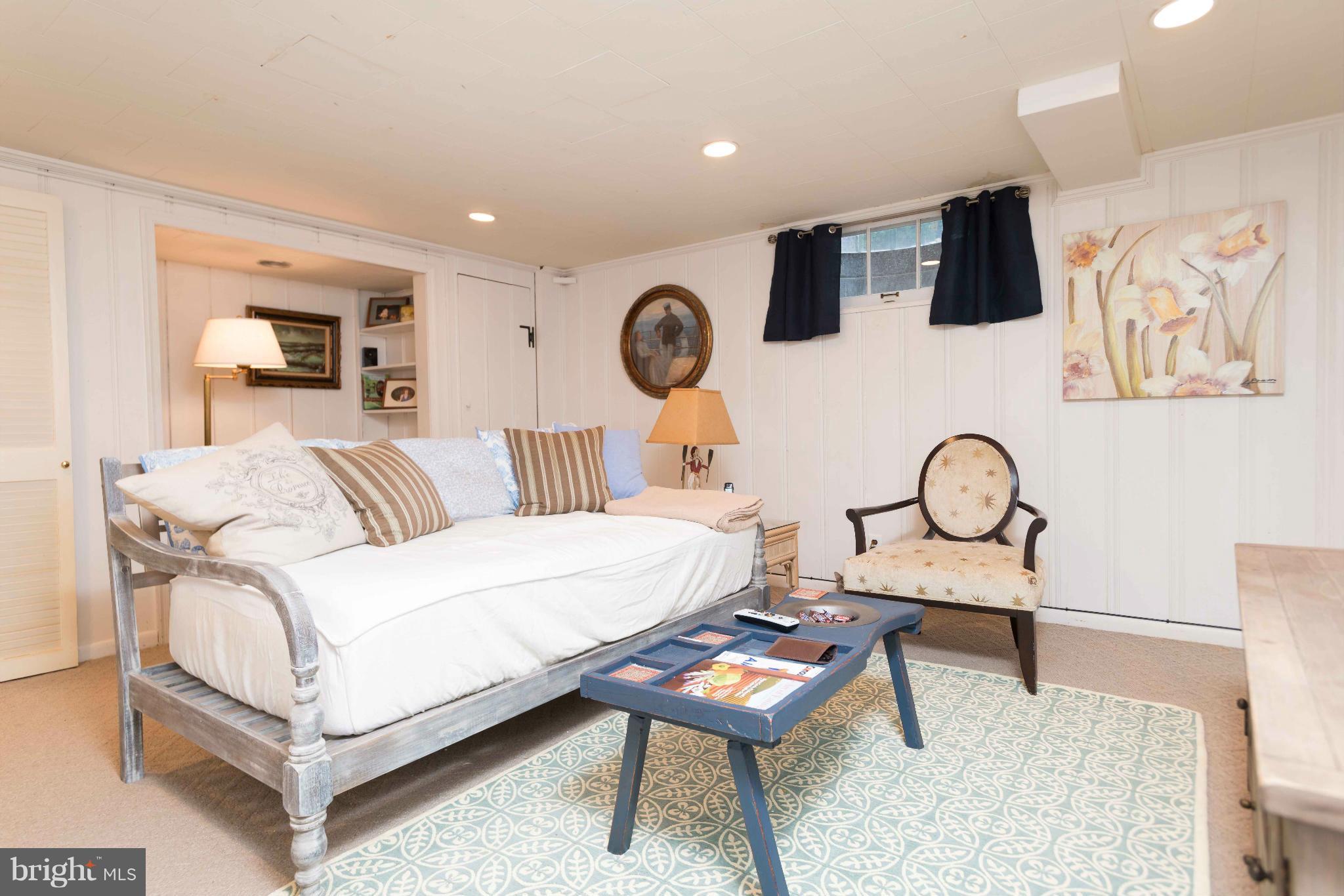 6420 Pinehurst Road Baltimore, MD 21212 - Photo 22 of 30 a bedroom with a bed a mirror and paintings on the wall