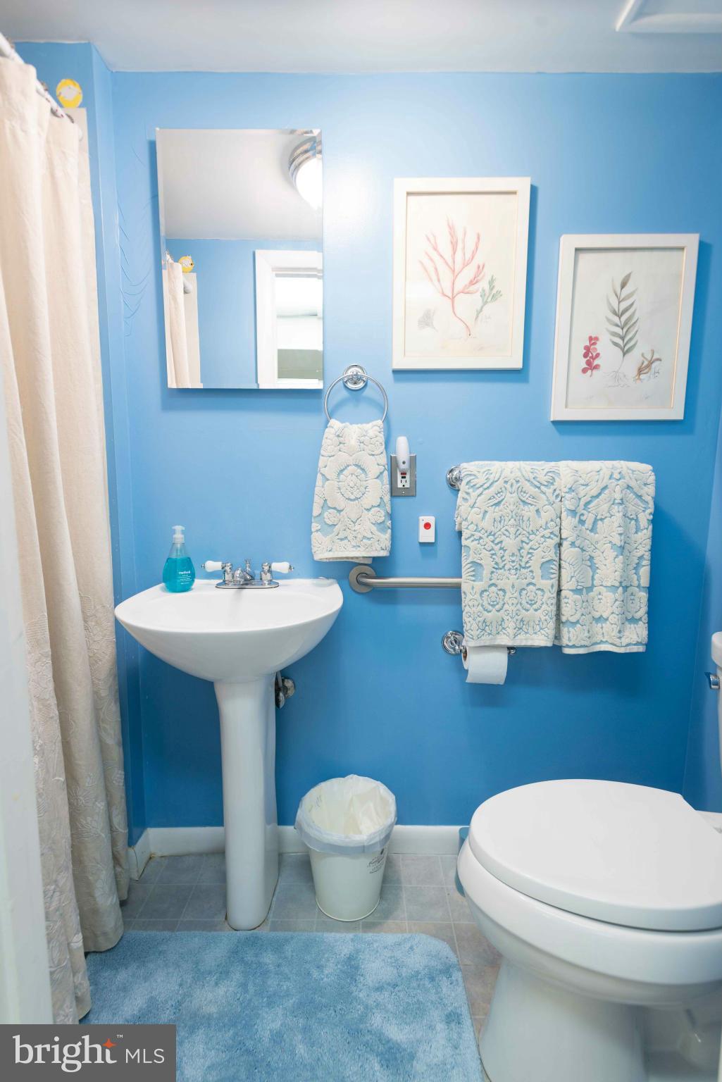 6420 Pinehurst Road Baltimore, MD 21212 - Photo 24 of 30 a bathroom with a toilet sink and mirror