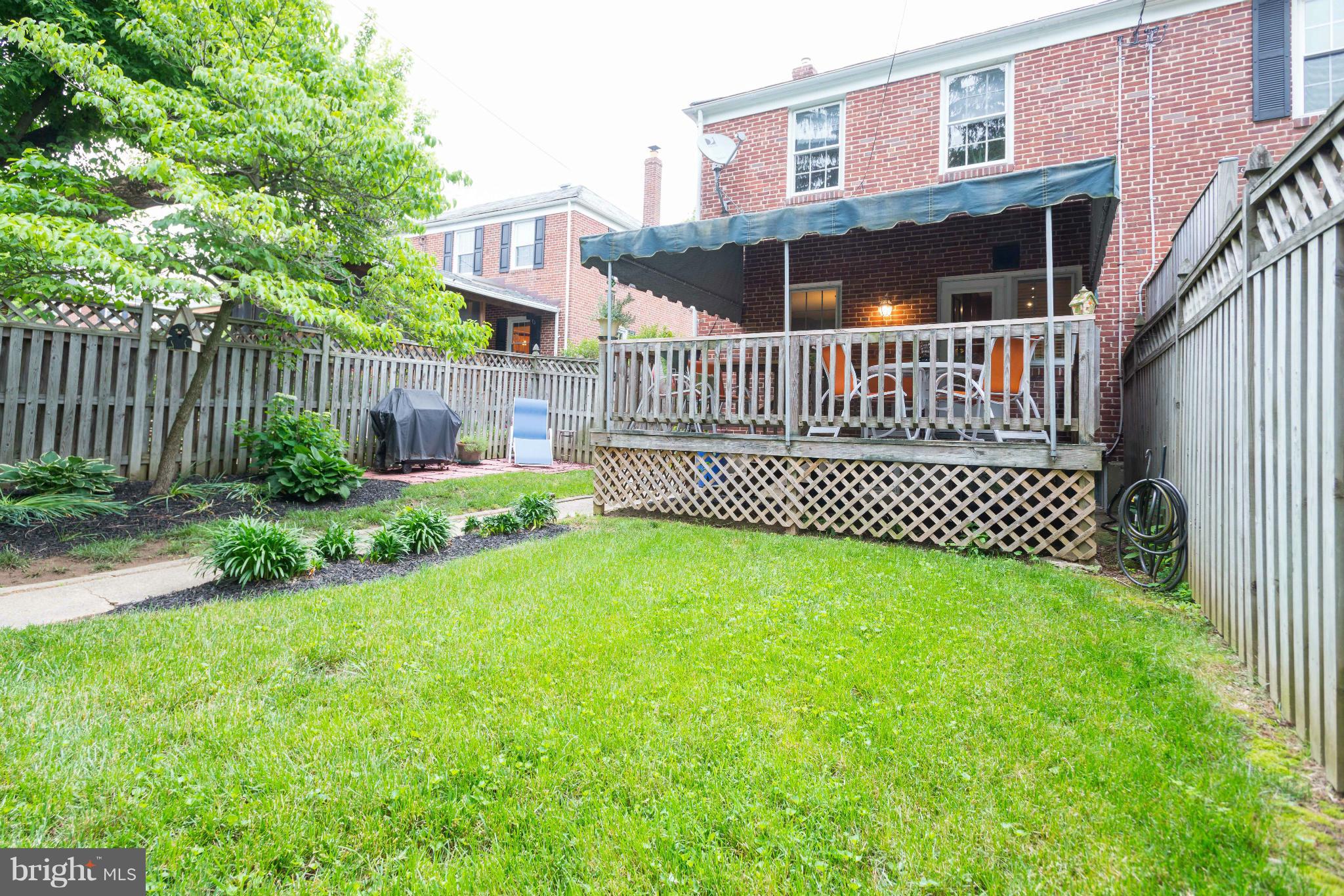 6420 Pinehurst Road Baltimore, MD 21212 - Photo 28 of 30 a view of a house with a small yard and wooden fence