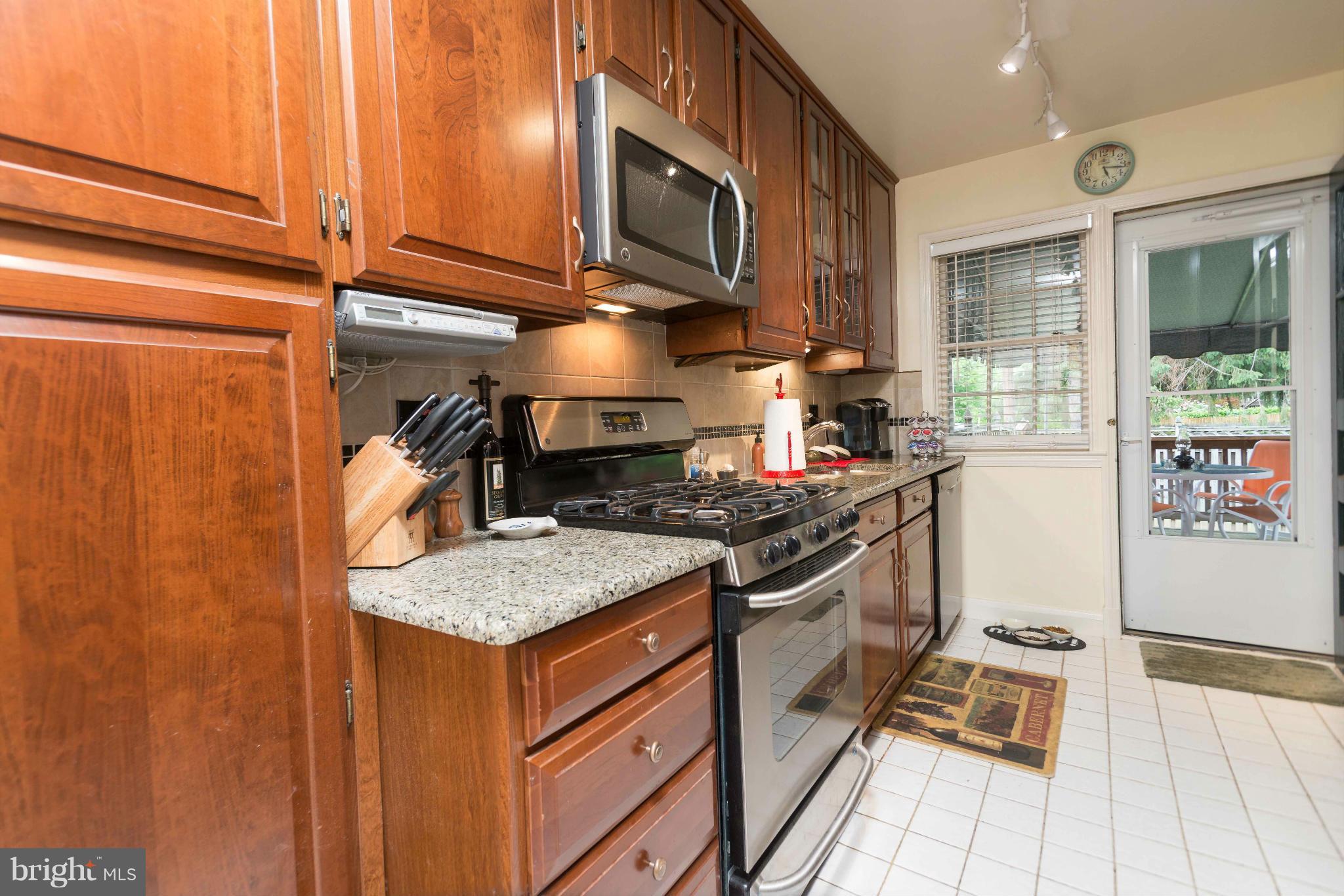 6420 Pinehurst Road Baltimore, MD 21212 - Photo 10 of 30 a kitchen with stainless steel appliances granite countertop a stove and a sink