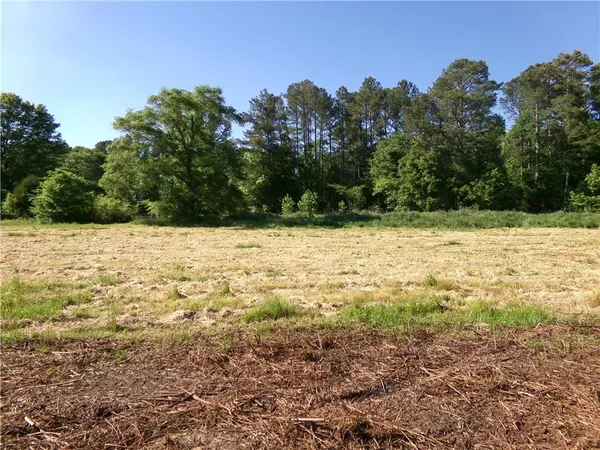 a view of a yard with a house in the background