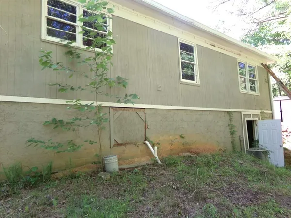 a view of a small house with green space