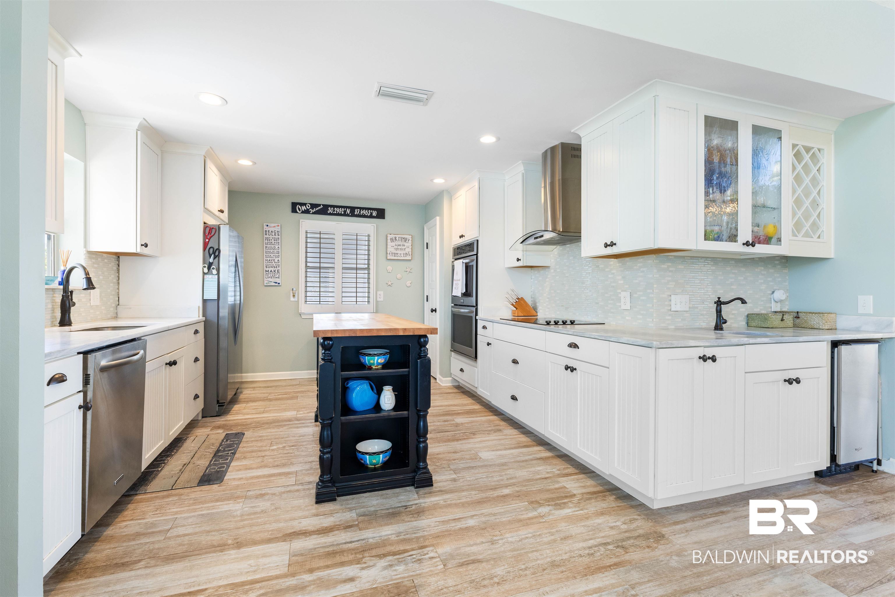 32315 River Road Orange Beach, AL 36561 - Photo 16 of 68 Kitchen with white cabinetry, stainless steel appliances, recessed lighting, wood like tile flooring, and wood counters