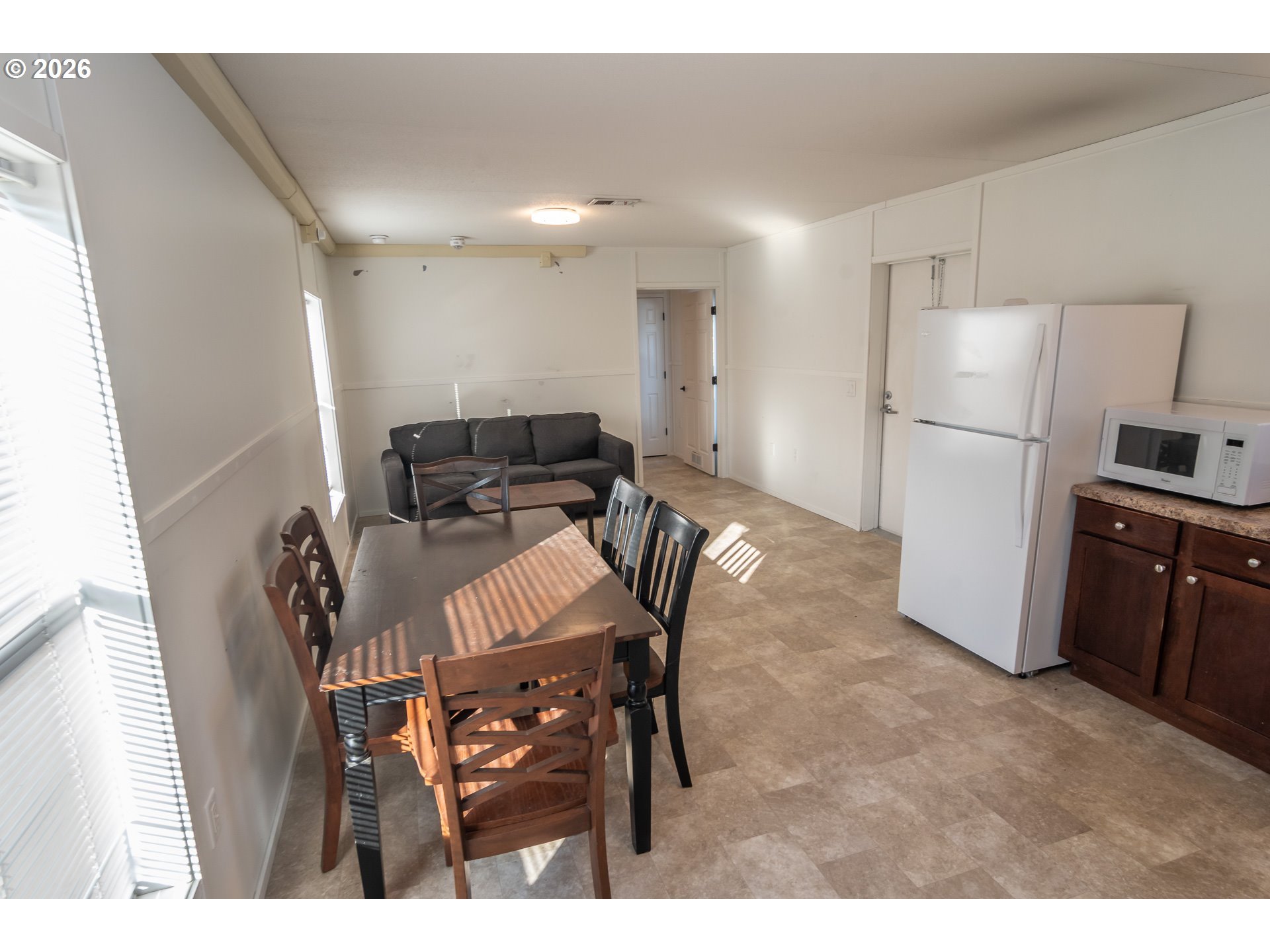 5000 Northeast Stephens Street, Unit 27 Roseburg, OR 97470 - Photo 19 of 24 a kitchen with stainless steel appliances kitchen island granite countertop a refrigerator a stove a sink a dining table and chairs