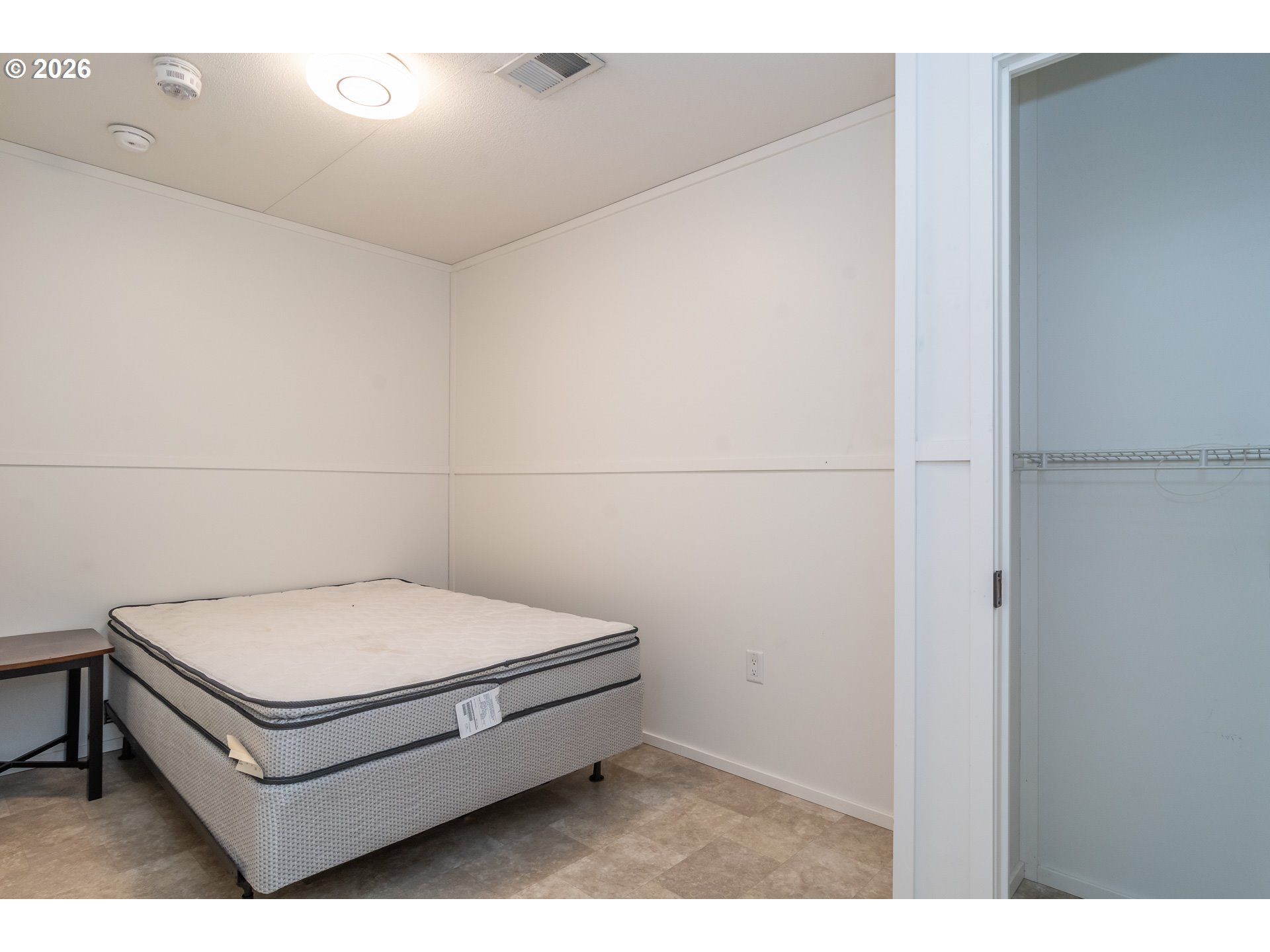 5000 Northeast Stephens Street, Unit 27 Roseburg, OR 97470 - Photo 21 of 24 a bathroom with a white bed and a shower