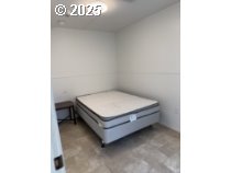 5000 Northeast Stephens Street, Unit 27 Roseburg, OR 97470 - Photo 4 of 24 a room with a bed and a table