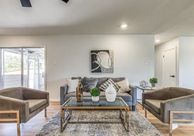 a living room with furniture and a potted plant