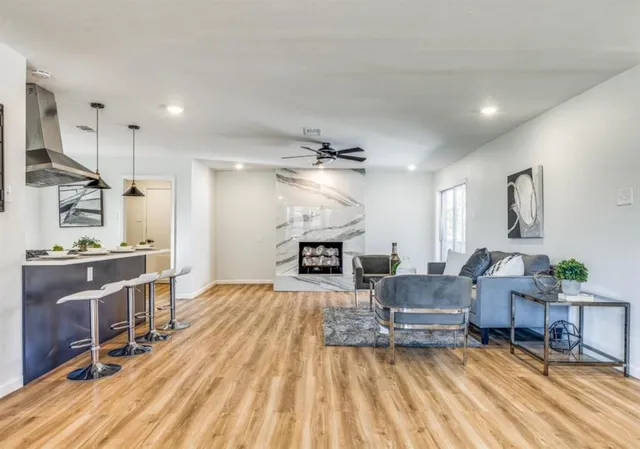 a living room with furniture and a wooden floor