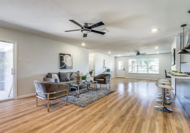a living room with furniture and a wooden floor