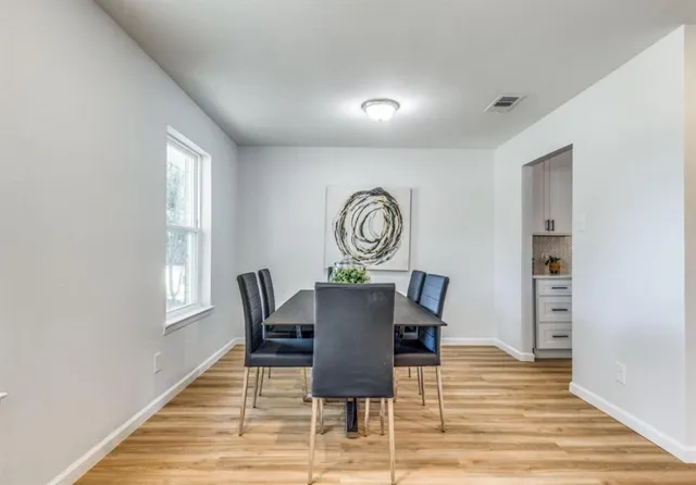 a view of a dining room with furniture and window