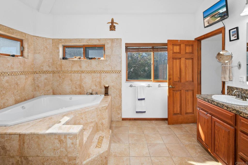 589 Anderson Road Alpine, CA 91901 - Photo 15 of 54 a bathroom with a tub sink and mirror
