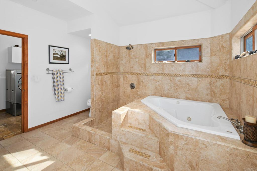 589 Anderson Road Alpine, CA 91901 - Photo 17 of 54 a bathroom with a bathtub and shower