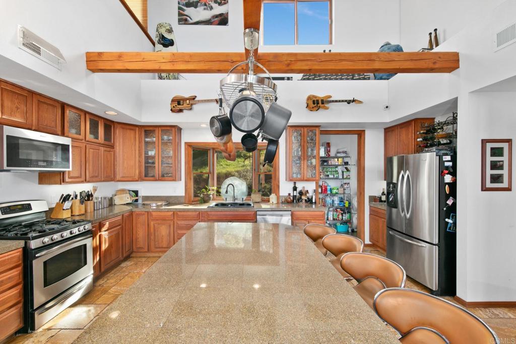 589 Anderson Road Alpine, CA 91901 - Photo 19 of 54 a kitchen with stainless steel appliances granite countertop a stove and cabinets