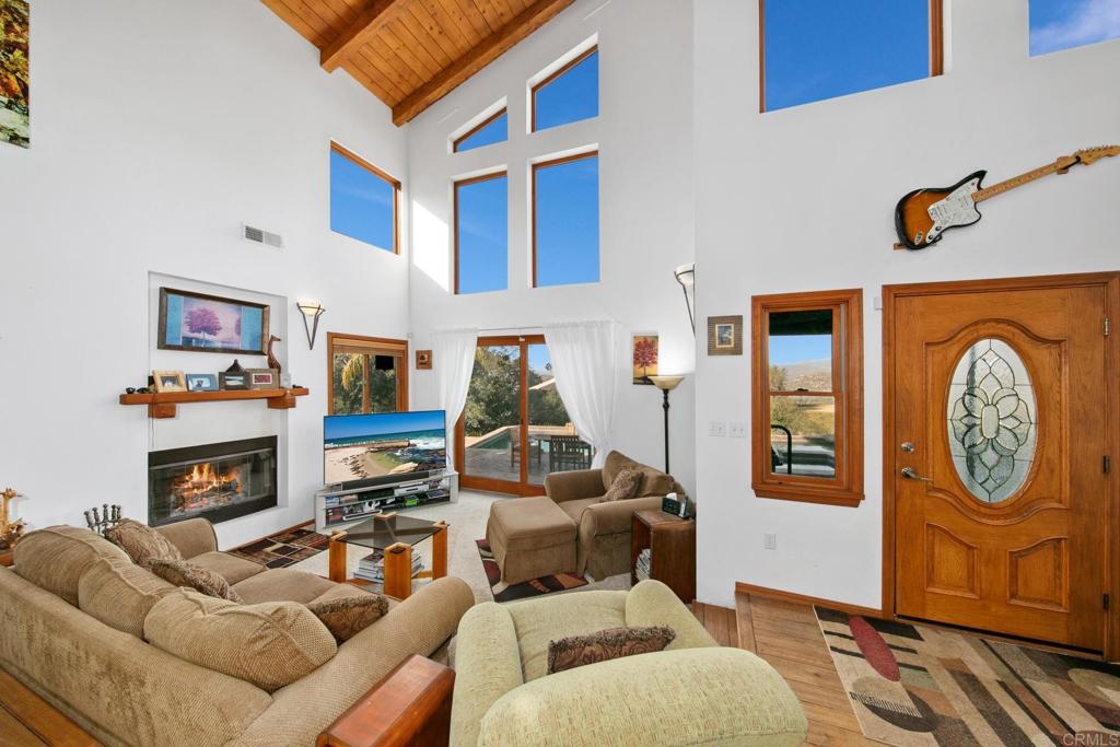 589 Anderson Road Alpine, CA 91901 - Photo 26 of 54 a living room with furniture a clock and a fireplace