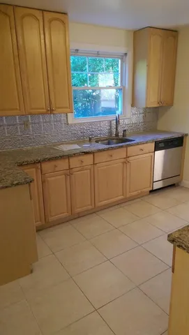 a kitchen with granite countertop a sink and a granite counter tops