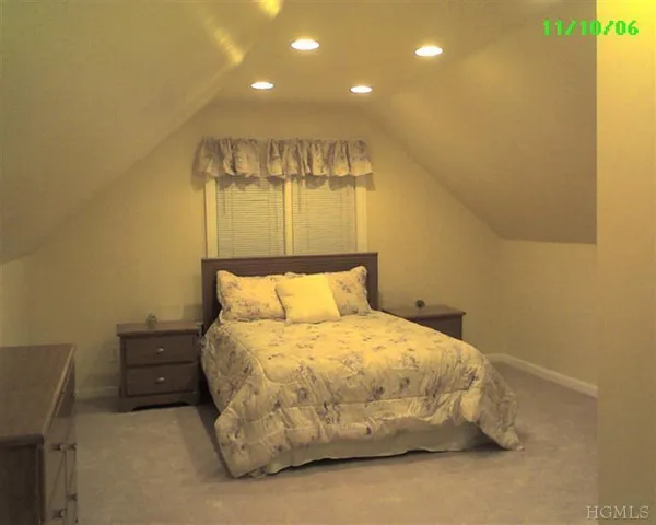 a bedroom with a bed and a night stand