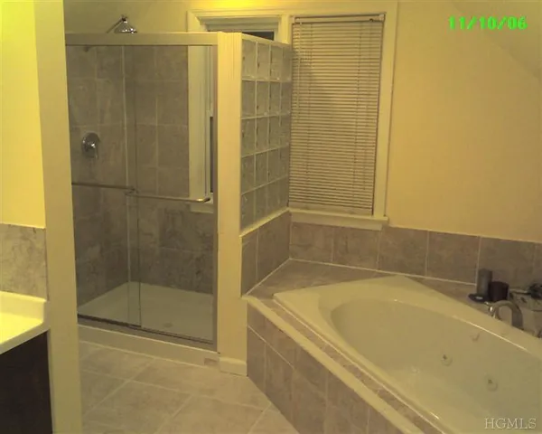 a bathroom with a bathtub and shower