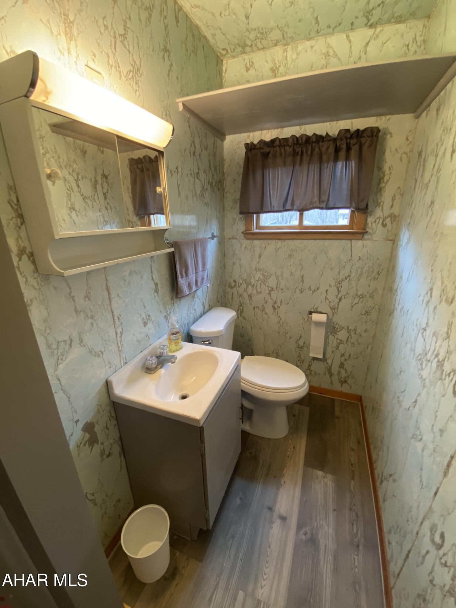 157 Stuckeysville Road Manns Choice, PA 15550 - Photo 8 of 28 a bathroom with a toilet a sink and a mirror