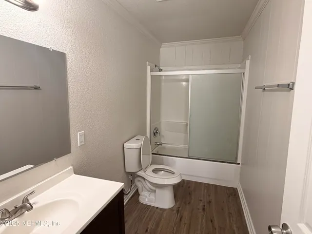 a white toilet sitting next to a bathroom sink
