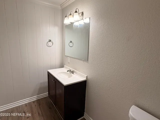 a bathroom with a sink toilet and mirror