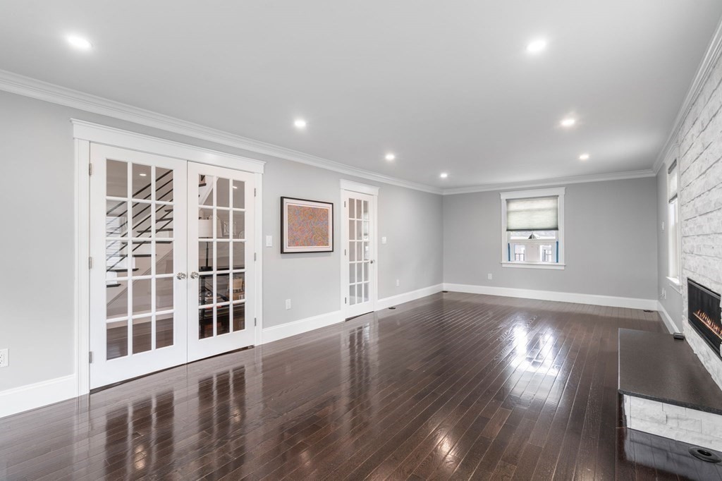 43 O'Neil Street Hudson, MA 01749 - Photo 11 of 39 a view of an empty room with wooden floor and a window