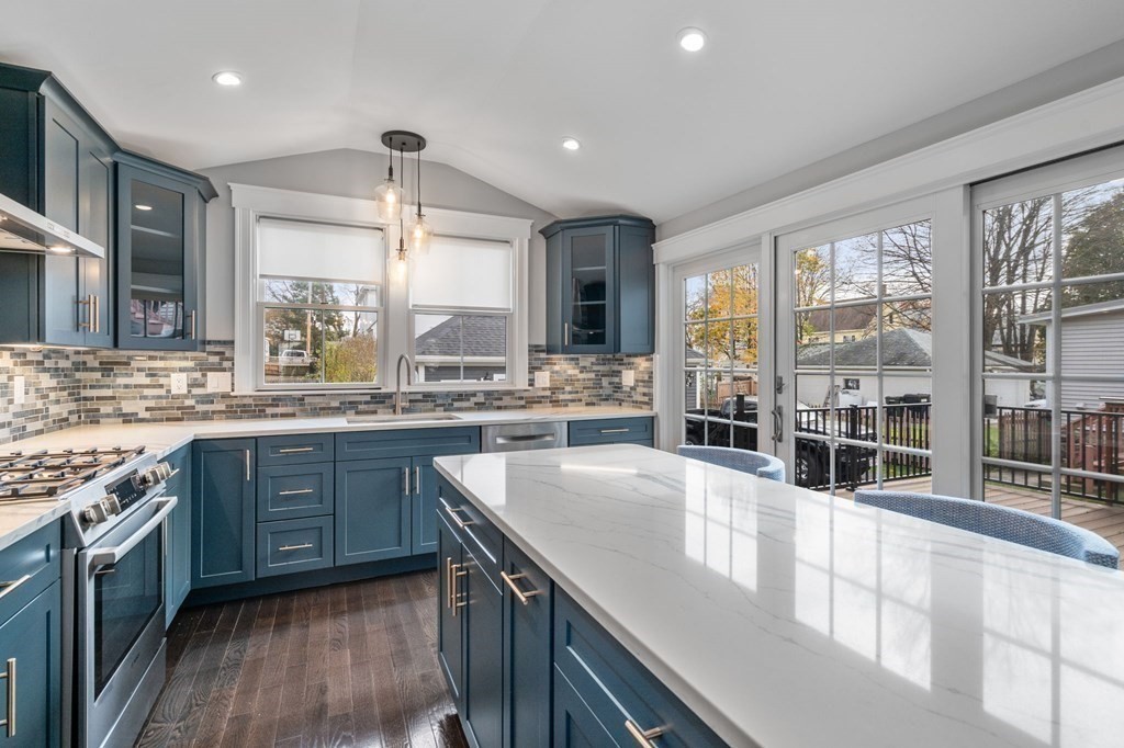 43 O'Neil Street Hudson, MA 01749 - Photo 16 of 39 a large kitchen with kitchen island granite countertop a large window and stainless steel appliances