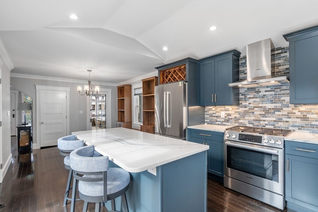 43 O'Neil Street Hudson, MA 01749 - Photo 18 of 39 a kitchen with stainless steel appliances kitchen island a stove and a refrigerator