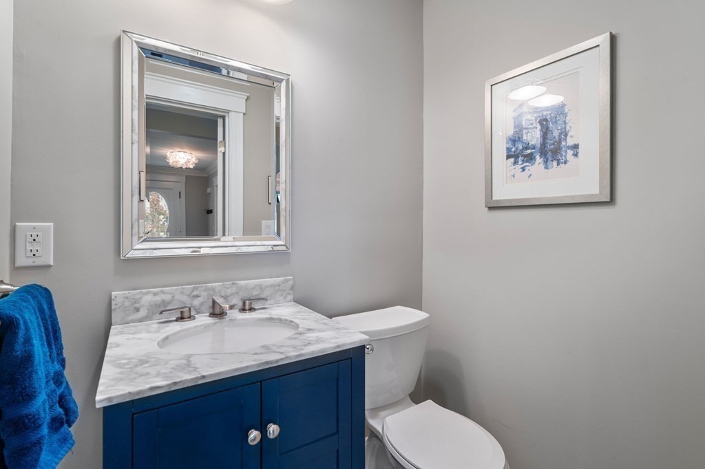 43 O'Neil Street Hudson, MA 01749 - Photo 20 of 39 a bathroom with a granite countertop toilet a sink and mirror